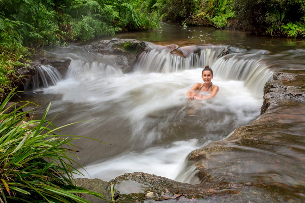 Backpackers washing in a natural spring