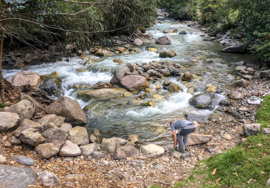 Backpackers washing clothes down by the river