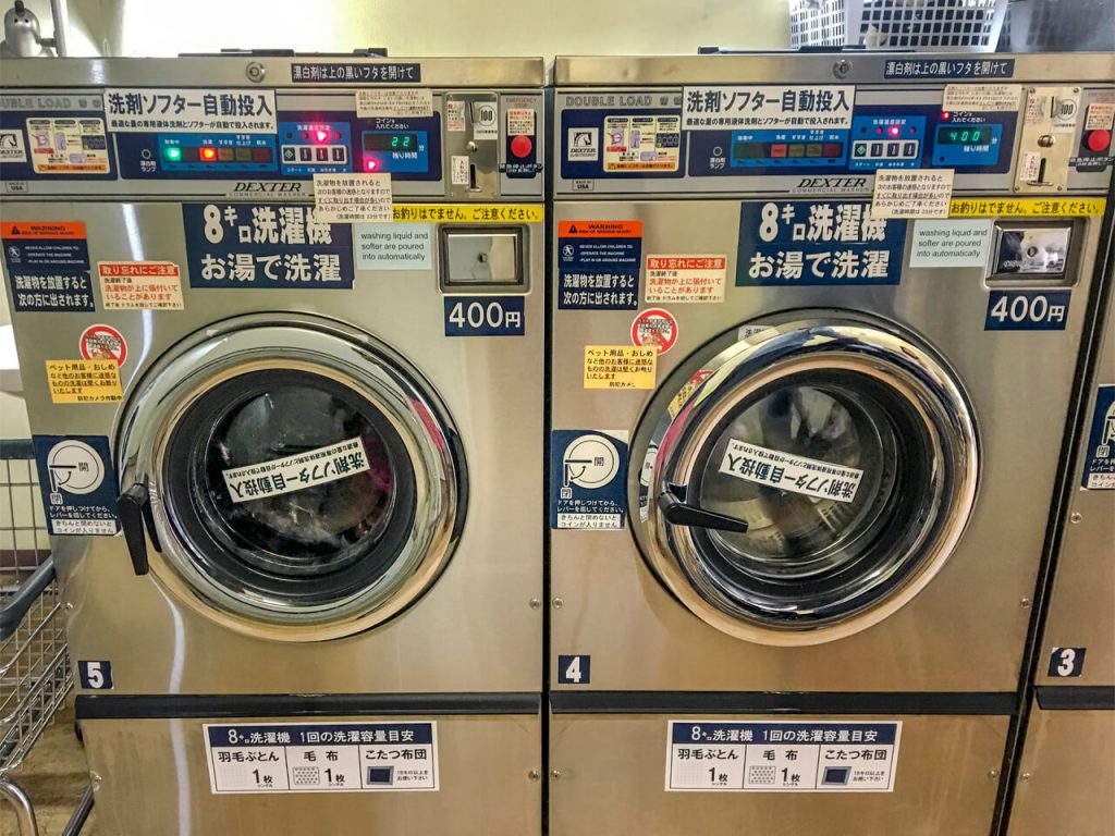 Backpackers using laundromats in Tokyo